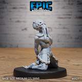 Kneeling thrall miniature with a broad, snarling monstrous face, head thrown back in anguish, chains around the wrists and torso, sparse cloth wrappings, sculpted by Epic Miniatures.