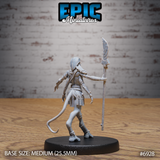 Lizardfolk warrior seen from behind, spear raised in the outstretched right hand with leaf-shaped blade prominent, scaled back and armour detail visible, engraved belt plaques and ankle bindings clear, tail curving left. Sculpt by Epic Miniatures.