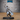 Bearded pirate captain lunging forward, cutlass raised in one hand, the other arm thrust overhead with tentacles coiling around the wrist and fist. Long buttoned frock coat mid-billow, tricorn hat. Sculpt by Epic Miniatures.