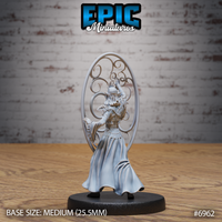 Gith Queen Spellshield by Epic Miniatures seen from behind — banded waist armour, billowing layered robes, one arm extended, surrounded by a large oval spellshield of interlocking decorative spirals.