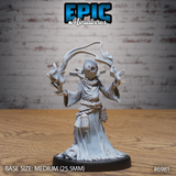 Robed cultist mage with arms raised and fingers splayed, channelling swirling energy ribbons from both hands, wearing a brimmed hat and eyeless wrapped mask with a sun emblem, rope-bound waist with hanging latticed lanterns. Sculpt by Epic Miniatures.