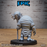 Rear view of the same hunched fiend, showing the broad rounded back wrapped in cloth robes and bindings, one clawed hand visible at the side, staff with skull totem held upright. Sculpt by Epic Miniatures.