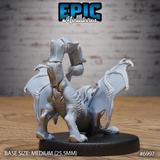 Manticore cub seen from behind, showing the full spread of leathery bat wings, muscular haunches, thick clawed feet, and arching barbed tail curling forward over the body. Sculpt by Epic Miniatures.