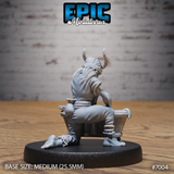 Tiefling villager seated at a wooden washtub viewed from behind, showing curved horns rising from a wrapped headscarf, rope coiled across the back, loose billowing tunic, small tied bundle on the ground beside bare feet. Sculpt by Epic Miniatures.