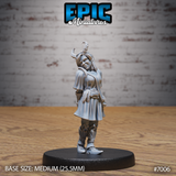 Tiefling girl miniature standing with head tilted and a half-smile, wearing a layered tunic, trousers and boots, with two asymmetric curved horns rising from her hair. Sculpt by Epic Miniatures.