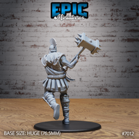 Broad-backed giant caught mid-stride, long white hair flowing beneath a plumed crested helm, scale armour covering the upper back and shoulders, rope-wrapped bracers visible, both arms extended to heave a heavy flat-faced spiked maul aloft. Sculpt by Epic Miniatures.