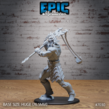Stone giant in a wide combat stance gripping a spear at chest height with one hand, swinging a rope-and-weight weapon overhead with the other. Heavy angular armoured plates cover the lower body; the torso is bare with pronounced musculature. Grimacing face with swept-back hair and short beard. Sculpt by Epic Miniatures.