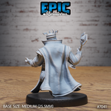 Dwarf king seen from behind, long robes sweeping dramatically outward, runic crown visible atop his head, right arm raised holding an ornate staff with a bird-like finial. The cloak drapes in deep fabric folds. Sculpt by Epic Miniatures.
