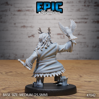 Dwarf druid seen from behind, long flowing hair with antler crown, hawk perched on her raised right fist with wings spread, feather-edged robe hem, a carved staff held loosely in the left hand. Sculpt by Epic Miniatures.