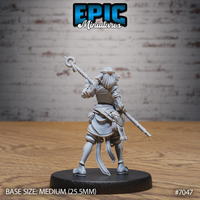 Firbolg druid seen from behind, staff angled upward, cloth cowl and braided cord detail visible across the back, wide-belted coat flaring at the hip, by Epic Miniatures.