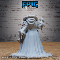 Female giant in a wide sweeping cloak viewed from behind, showing a fur-trimmed hood, rope-bound staff slung across her back, and a flame raised in her left hand. Detailed greaves and boot wraps visible. Epic Miniatures sculpt.