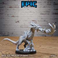 Obsidian Guard Drake rearing on hind legs, mouth open with a billowing breath weapon effect extending forward, overlapping scales across neck and spine, rocky sculpted base. By Epic Miniatures.