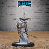 Wide-brimmed tall hat and voluminous tattered robe viewed from behind, spear-halberd angled outward, long matted hair visible beneath the hat, skeletal bony hands and armoured boots. Grave Digger by Epic Miniatures.