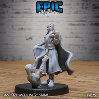 Long-haired vampire sorcerer holding a goblet aloft, wearing a billowing cape and long coat, with a kneeling figure grasping at his leg at the base. Sculpt by Epic Miniatures.