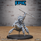 Werespider miniature seen from behind and below, showing the heavily plated spider abdomen with layered chitin, barbed leg tips, and the warrior's spear arm raised high. Sculpt by Epic Miniatures.