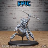 Werespider miniature seen from behind and below, showing the heavily plated spider abdomen with layered chitin, barbed leg tips, and the warrior's spear arm raised high. Sculpt by Epic Miniatures.