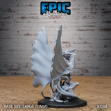 Fairy dragon miniature seen from behind, large veined membranous wings dominating the silhouette, tail wrapped around a weathered stone base. Sculpt by Epic Miniatures.