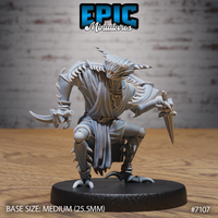 Crouching insectoid creature holding a dagger in its right hand and a curved pincer-claw in its left, wearing tattered robes and spiked chitin armour, horned head angled forward. Sculpt by Epic Miniatures.