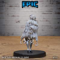 Dryad miniature by Epic Miniatures seen from behind, revealing an elaborate cascade of long hair densely interwoven with broad autumnal leaves and fine vein detail, with curling root-like tendrils emerging at the base of the skirt.