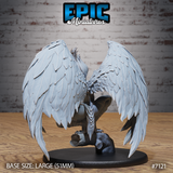 Winged female figure viewed from behind, enormous feathered wings dominating the composition with layered individual feathers clearly defined, crouched posture visible, taloned feet on a textured log and rock base. Sculpt by Epic Miniatures.