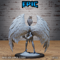 Winged goddess seen from behind, showing the full spread of densely layered feathered wings with individually sculpted primary and covert feathers, wild hair rising from the crown, and a scenic broken-stone base. Sculpt by Epic Miniatures.
