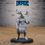 Muscular moose-headed tribal warrior standing upright, both hands raised with fingers splayed, wearing rope bindings on arms and waist, bone necklace, and a layered feather-and-hide kilt. Wide-spread antlers curve overhead. Sculpt by Epic Miniatures.
