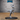 Raptor centaur female miniature by Epic Miniatures: humanoid upper body in corset armour with one arm raised behind her head, raptor lower body with one foreleg lifted and a wrapped tail extended. Mounted on a large oval base.