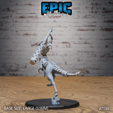Raptor Centaur female miniature seen from behind, showing ridged spinal scaling along the theropod body, bound tail wraps, and spiked back detail, balanced on one clawed foot on a sculpted base. By Epic Miniatures.
