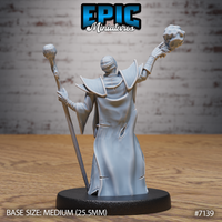 Necromancer with arms outstretched, one hand raising a jagged orb overhead and the other gripping a tall staff, seen from the rear showing a broad caped silhouette, smooth flowing robes and segmented back armour. Sculpt by Epic Miniatures.