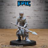 Armoured zombie drow soldier crouching forward with a long spear levelled at waist height, wearing layered plate armour decorated with skull motifs and a chainmail skirt over tattered robes. Sculpt by Epic Miniatures.