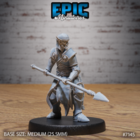 Armoured zombie drow soldier crouching forward with a long spear levelled at waist height, wearing layered plate armour decorated with skull motifs and a chainmail skirt over tattered robes. Sculpt by Epic Miniatures.