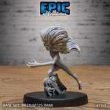 Shrieking undead female figure lunging forward with one arm outstretched and clawed fingers grasping, wild long hair streaming back, mounted on a cracked gravestone base decorated with skulls. Sculpt by Epic Miniatures.