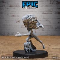 Shrieking undead female figure lunging forward with one arm outstretched and clawed fingers grasping, wild long hair streaming back, mounted on a cracked gravestone base decorated with skulls. Sculpt by Epic Miniatures.
