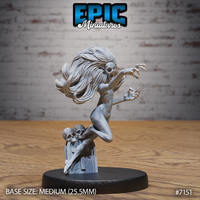 Gaunt female undead spirit rising from a skull-topped grave pillar, arms outstretched with clawed fingers, wild hair flowing sideways, hollow eye sockets, by Epic Miniatures.