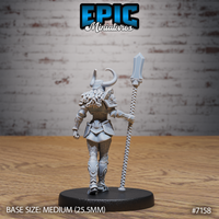 Armoured female undead knight seen from behind, thick fur-lined cloak over engraved pauldrons, scaled leg armour, holding a coiled vertebral staff at her side, horned helmet, Epic Miniatures sculpt.