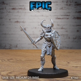 Armoured female knight standing in a guarded stance, sword extended forward, holding a kite shield embossed with a screaming face. Breastplate carved with a weeping mask, twin-horned helm. Sculpt by Epic Miniatures.