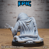 Robed crouching figure seen from behind, revealing smooth flowing cloth folds over segmented riveted leg and arm armour, bladed claw gauntlet visible at the side. Sculpt by Epic Miniatures.