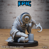 Crouching robed creature with a single large eye set in an iron-rimmed socket, gripping a hooked serrated blade, beside a small cylindrical object. Sculpt by Epic Miniatures.