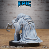 Robed creature seen from behind, voluminous tattered cloak pooling around crossed legs, one arm raised holding a hooked blade with serrated inner edge. Sculpt by Epic Miniatures.