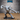 Headless chain-wrapped construct lunging forward with one claw-tipped arm outstretched and one fist raised, riveted patchwork torso stitched along the chest, heavy chains looping its limbs, by Epic Miniatures.