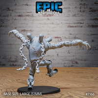 Rear view of Experiment Alpha Jump by Epic Miniatures: stitched and riveted torso with thick chain links draped across the back, elongated banded arms reaching outward, heavy mechanical boots, one foot raised mid-stride.