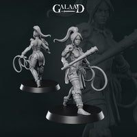 Grey resin unpainted miniature of a female amazon warrior shown from front and back. She wears wrapped leg bindings and feathered headgear, carries a staff held across her body, and holds a coiled whip at her side. She is posed mid-stride on a round black display base. Digital render by Galaad Miniatures, 32mm scale.