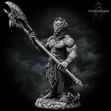 Fire Giant standing with poleaxe lowered at his side, broad torso with cracked bark-like skin, wild mane of hair, flame-engraved belt and kilt, one hand trailing near the ground, textured scenic base. Sculpt by Stormborn Collectibles.