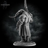 Rear view of the unpainted grey resin loxodon miniature showing thick hide texture across the back, wide-set tusks, and the runic text around the base, with the scythe blade visible over the left shoulder