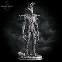 Digital render of an unpainted grey Treant miniature from Stormborn Collectibles — straight-on front view showing full skeletal bark torso, gnarled branch arms, and pointed antler head crown against a stormy background