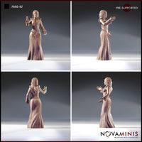 Four-angle photograph of Novaminis Noble 02 printed miniature — showing front, side, rear, and three-quarter views of the noblewoman in her detailed embroidered gown and chain belt, unpainted grey resin, pre-supported, 32mm scale