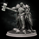 Three-quarter front angle of a bald warrior in sun-emblazoned armour raising an ornate warhammer overhead, large spiked shield at his side, skulls and rubble at his feet. Sculpt by Stormborn Collectibles.