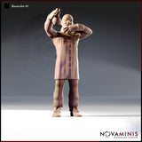 Front view digital render of Researcher 01 — a bald, broad-shouldered male figure in a long buttoned coat, arms raised holding an alchemical flask aloft with an intense expression, 32mm scale Novaminis miniature, unpainted resin