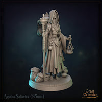Agatha Saltwick miniature seen from behind: enormous woven basket on her back topped with a mortar and pestle, pouches hanging from netting, staff held at her side. Sculpt by Great Grimoire.