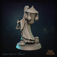Agatha Saltwick miniature close detail view: hooded face with aged features partially shadowed, rope-wrapped staff, braided cord belt, and layered robes with ragged hem. Sculpt by Great Grimoire.